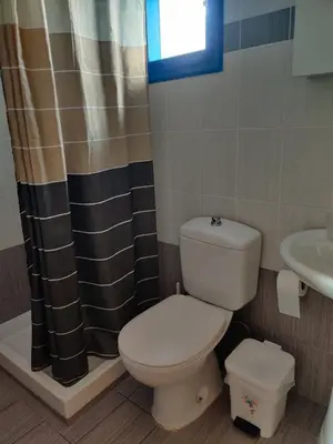 a bathroom with a toilet and a sink at Blue Sky Aparts in Livadia