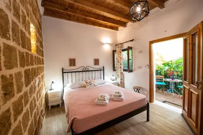 a bedroom with a bed with two towels on it at Medieval Inn in Rhodes Town