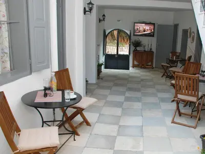 a hallway with a table and chairs and a door at Medieval Inn in Rhodes Town