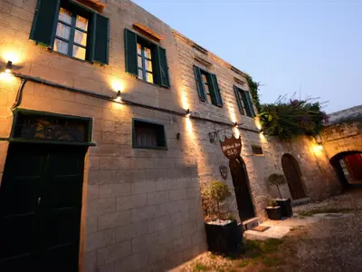 a brick building with a door and lights on it at Medieval Inn in Rhodes Town