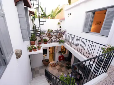 an internal view of a house with plants on the stairs at Medieval Inn in Rhodes Town