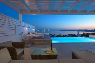 a villa with a swimming pool at night at Villa Mimosa in Pefkos (Lindos area) in Líndos