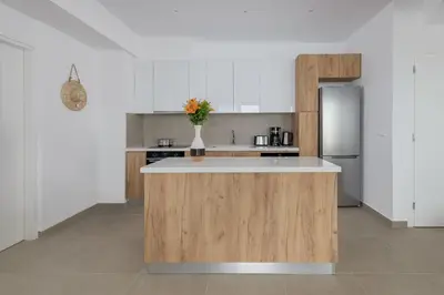 a kitchen with a island in the middle of a room at Villa Mimosa in Pefkos (Lindos area) in Líndos