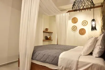 a bedroom with a bed with a canopy at Rafael Hotel-Adults Only in Líndos