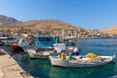 a group of boats docked in a body of water at Anastasia house in Halki