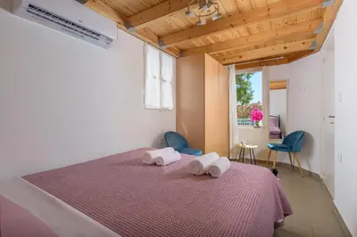 a bedroom with a bed with two towels on it at Anastasia house in Halki