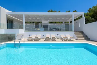 a villa with a swimming pool and a house at Villa Dione in Pefkos, Lindos area in Líndos