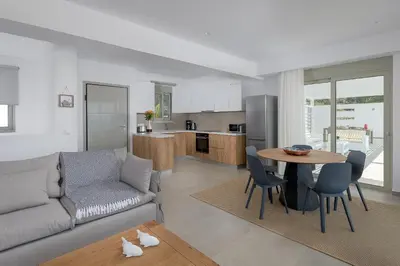 a living room with a couch and a table at Villa Dione in Pefkos, Lindos area in Líndos