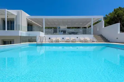 a swimming pool in front of a house at Villa Dione in Pefkos, Lindos area in Líndos