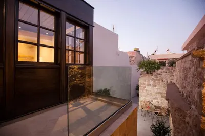 a house with a glass door on a balcony at Casa Quindici in the Old Town in Rhodes Town