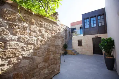 a building with a stone wall and a courtyard at Casa Quindici in the Old Town in Rhodes Town