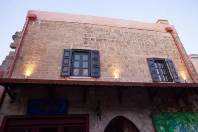 two windows on the side of a brick building at Casa Quindici in the Old Town in Rhodes Town