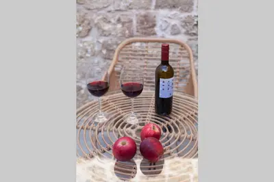 a basket with two glasses of wine and some apples at Casa Quindici in the Old Town in Rhodes Town