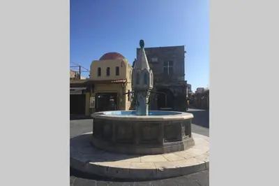 a fountain in the middle of a street at Casa Quindici in the Old Town in Rhodes Town