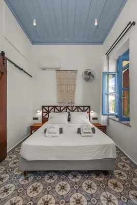 a bedroom with a large bed in a room at Casa del Sol Suites in Rhodes Town