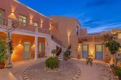 a large house with a courtyard with a staircase at Casa del Sol Suites in Rhodes Town