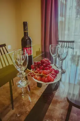a table with a bottle of wine and a plate of fruit at villa62rodos in Kremasti
