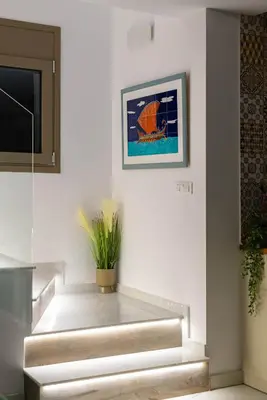 a stairway with a painting and a plant on the wall at Ikaros Villa in Pefki Rhodes