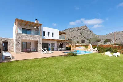 a house with a yard with a swimming pool at Ikaros Villa in Pefki Rhodes