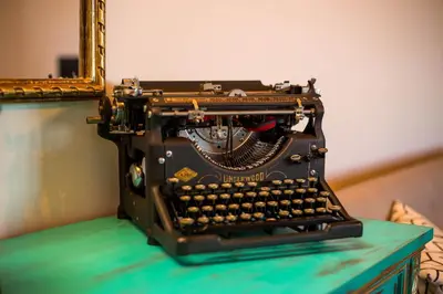 an old typewriter sitting on a table with a mirror at Old Nest House in Sálakos
