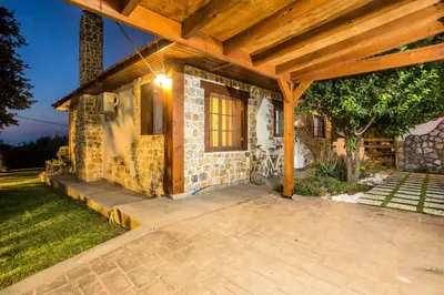 a brick house with a wooden roof at Old Nest House in Sálakos