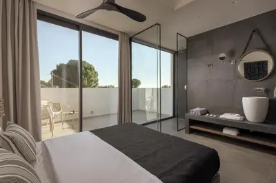 a bedroom with a bed and a large window at Bianco Villa - Eve in Pefki Rhodes
