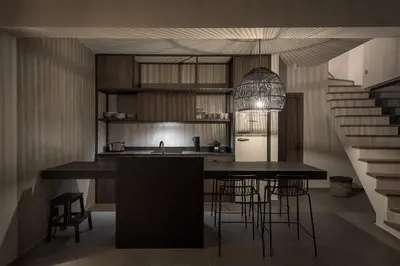a kitchen with a counter and a kitchen island with chairs at Bianco Villa - Eve in Pefki Rhodes