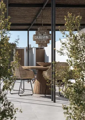 a patio with a table and chairs and a chandelier at Bianco Villa - Eve in Pefki Rhodes