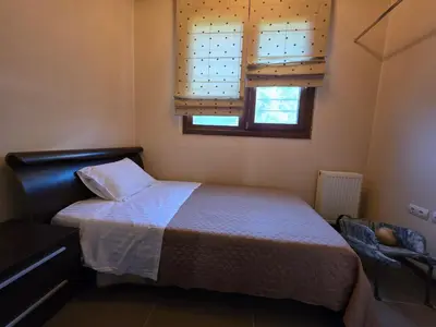 a small bedroom with a bed and a window at Villa Astravi in Ialyssos