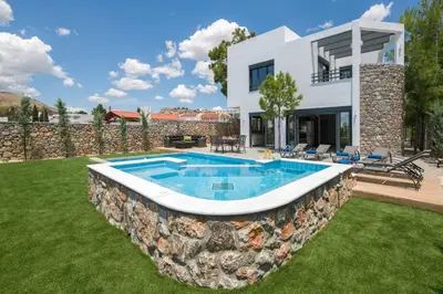 a house with a swimming pool in a yard at Villa Summer Dawn in Kiotari