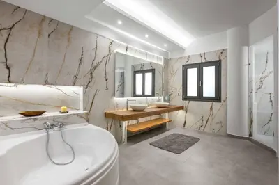a bathroom with a tub and a toilet and a sink at Villa Summer Dawn in Kiotari