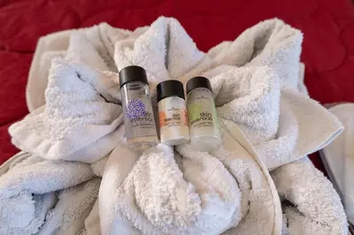 two bottles of essential oils sitting on a white towel at Knights' Castle Studios in Archangelos