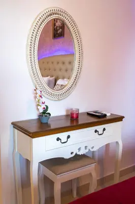 a dressing table with a mirror on top of it at Knights' Castle Studios in Archangelos