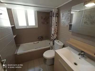 a bathroom with a toilet and a tub and a sink at Elli beach apartment top location Rodos in Rhodes Town