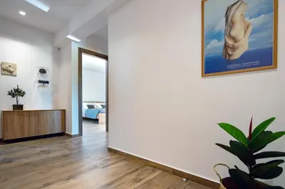 a living room with a large white wall at Rosemary Rhodes Villa in Malona Village