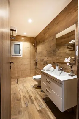a bathroom with a sink and a toilet at Rosemary Rhodes Villa in Malona Village
