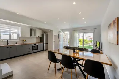 a kitchen and dining room with a table and chairs at Rosemary Rhodes Villa in Malona Village