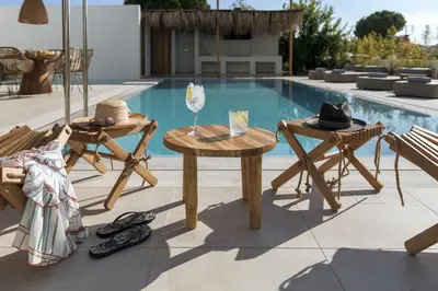a table and chairs next to a swimming pool at Bianco Villa - Adam in Pefki Rhodes