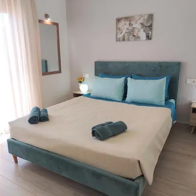 a bedroom with a large bed with two pillows on it at Depie Luxury Apartment in Pastida Rhodes in Pastida
