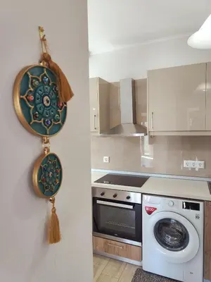 a kitchen with a stove and a washing machine at Depie Luxury Apartment in Pastida Rhodes in Pastida