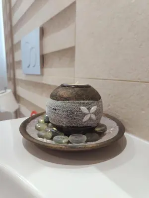 a vase sitting on top of a table with rocks at Depie Luxury Apartment in Pastida Rhodes in Pastida