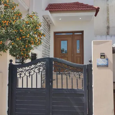 a black gate in front of a house at Depie Luxury Apartment in Pastida Rhodes in Pastida