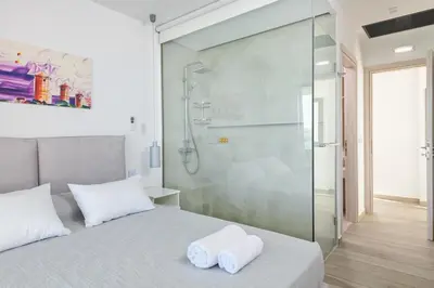 a bedroom with a shower and a bed with two towels at Villa Kastro in vlicha