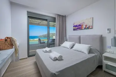 a bedroom with a bed with two towels on it at Villa Akrotiri in vlicha