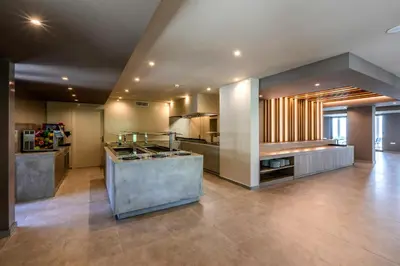 a large kitchen with a counter in the middle at White Olive Premium Lindos in Pefki Rhodes