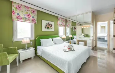 a green bedroom with a bed and a mirror at City Mansion Rhodes in Rhodes Town