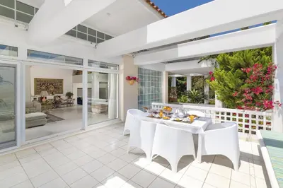 an outdoor patio with white tables and chairs at City Mansion Rhodes in Rhodes Town