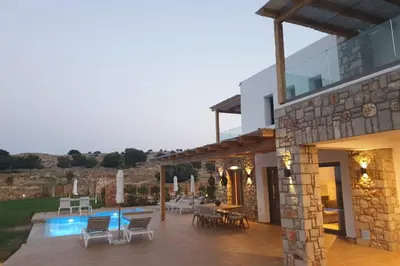 a house with a patio and a swimming pool at Villa Alkyoni Lindos in Líndos