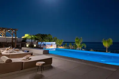 a resort with a swimming pool at night at Lido White Villa in Pefki Rhodes