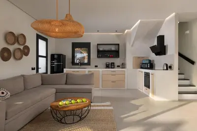 a living room with a couch and a table at Lido White Villa in Pefki Rhodes